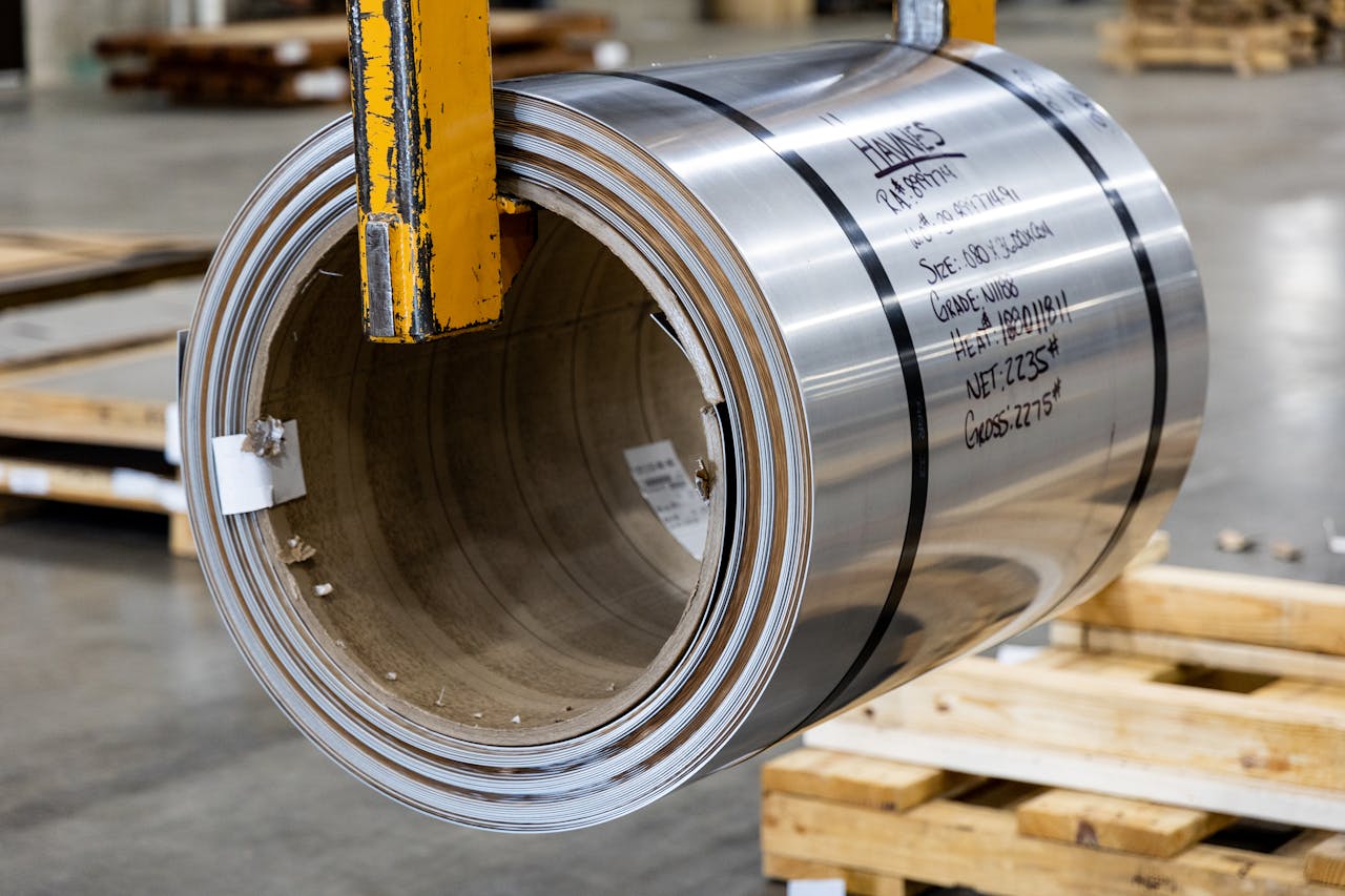 Steel coil in a modern warehouse, showcasing industrial materials ready for manufacturing.